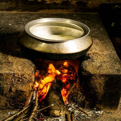 Boiling milk over a wood fire