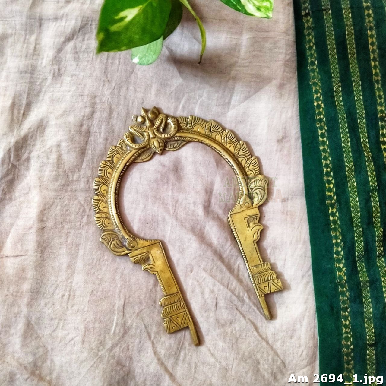 brass prabhavali on white fabric