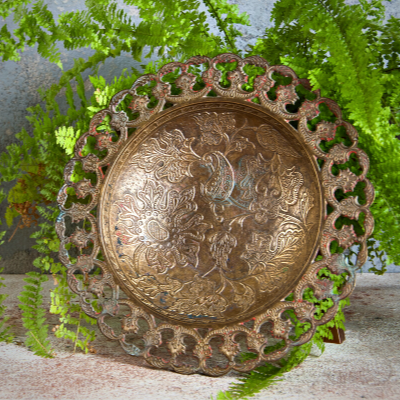 ornate, wide and shallow brass bowl
