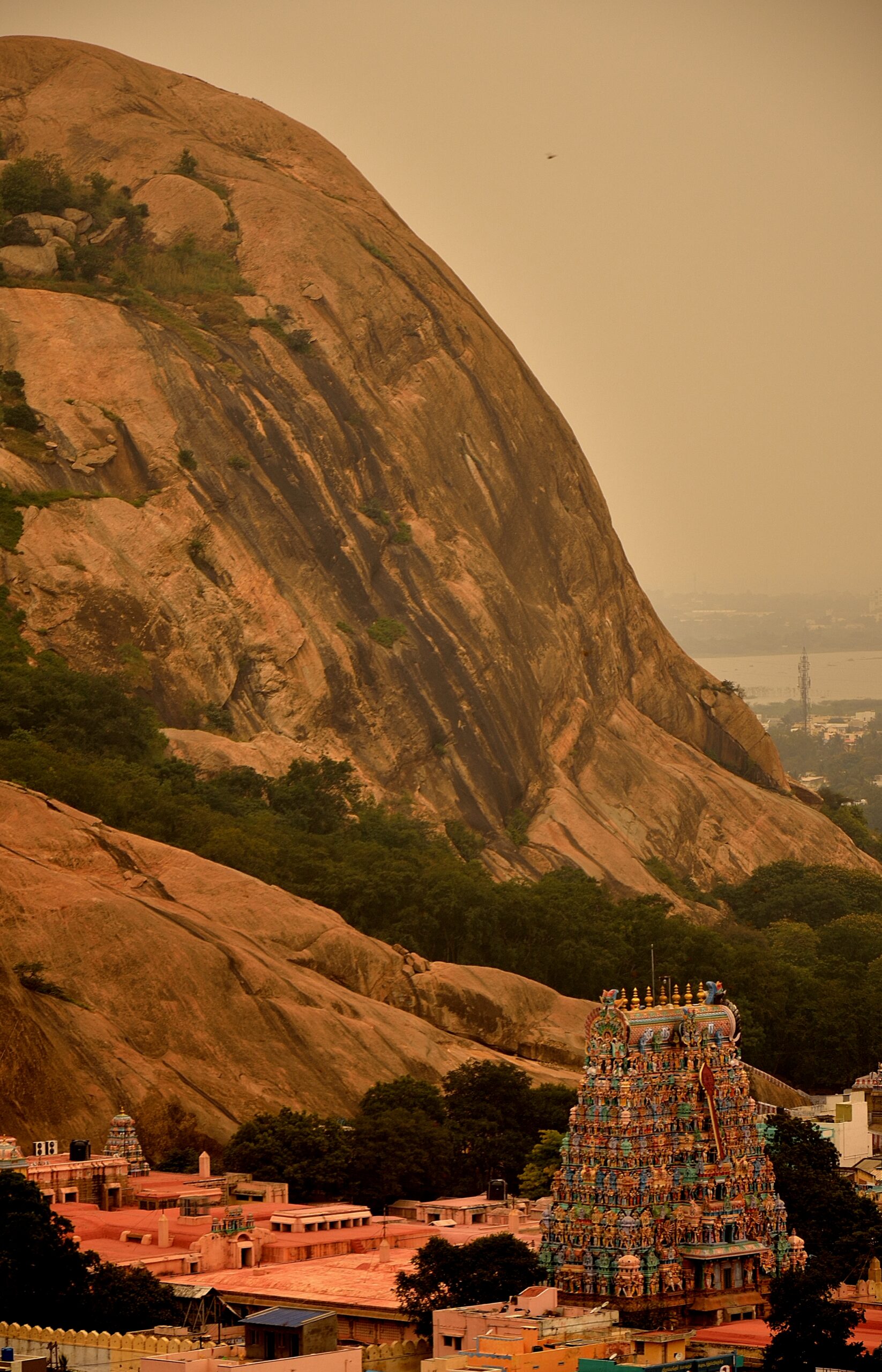 archaeological monuments in and around madurai : tirupankundram rock face overlooking the temple gopuram below