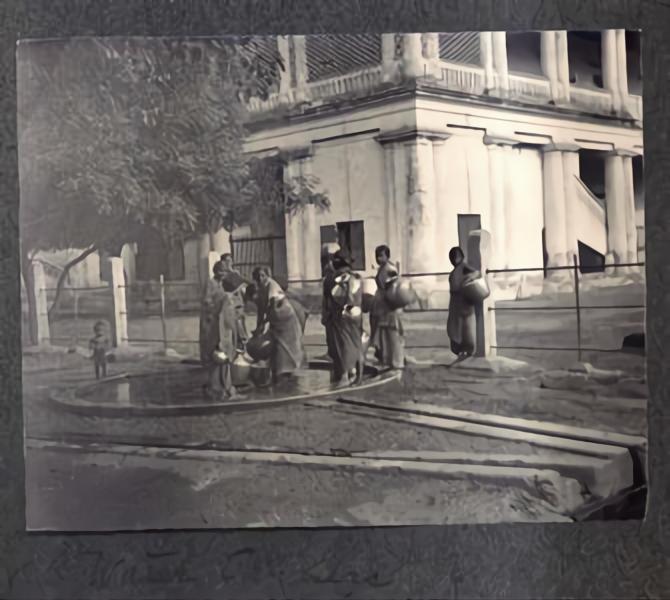An image of women filling and carrying pots of water in the temple town of Madurai in the year 1904