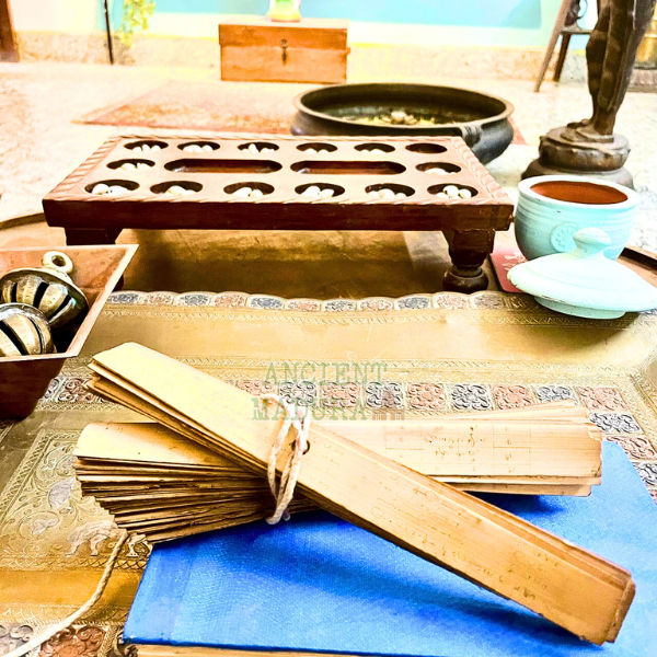 A bundle of Olai Chuvadi manuscripts set on a table