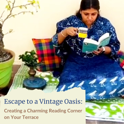 A woman sits sipping on tea while reading a book in a newly set up vintage reading corner on her terrace