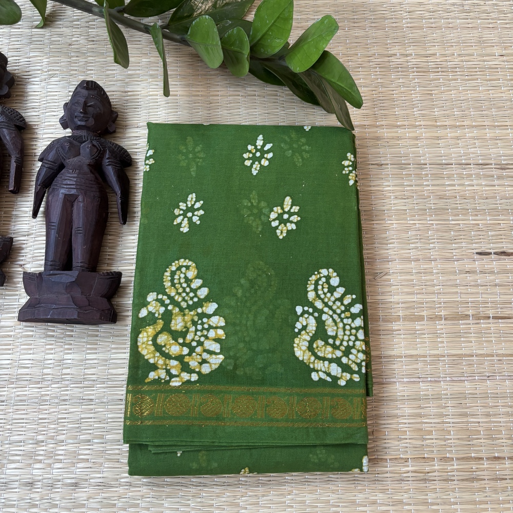 Leaf green sungudi batik saree with white and yellow-tinged peacock motifs and gold zari border