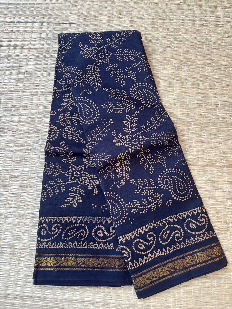 Navy blue sungudi batik saree with cream vine motifs, double mango border and framed floral pallu panels