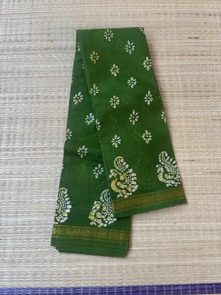 Leaf green sungudi batik saree with white and yellow-tinged peacock motifs and gold zari border