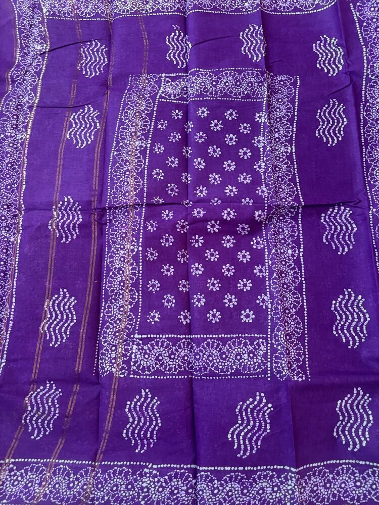 Purple sungudi batik saree with lilac peacock feather motifs and gold zari border