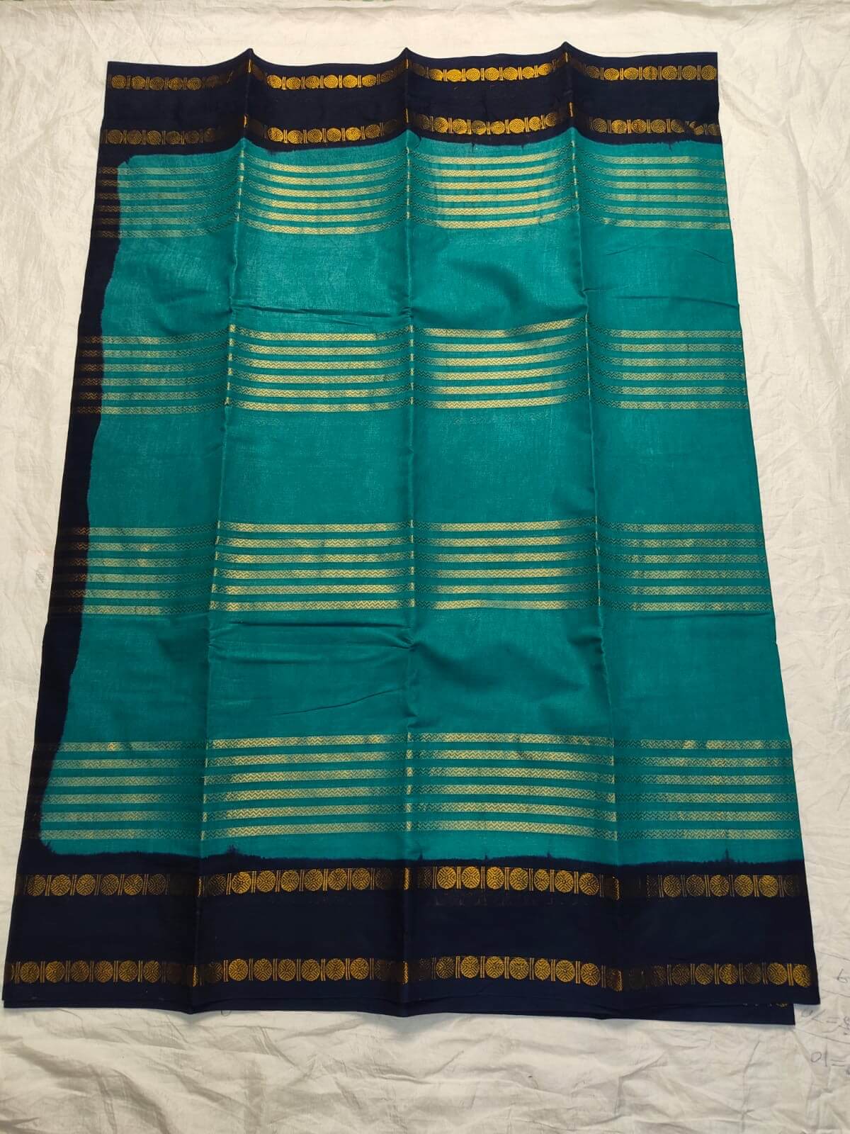 Teal green Neli Velthari sungudi saree with navy Rettapet Rudraksha border, Madurai handcrafted cotton saree