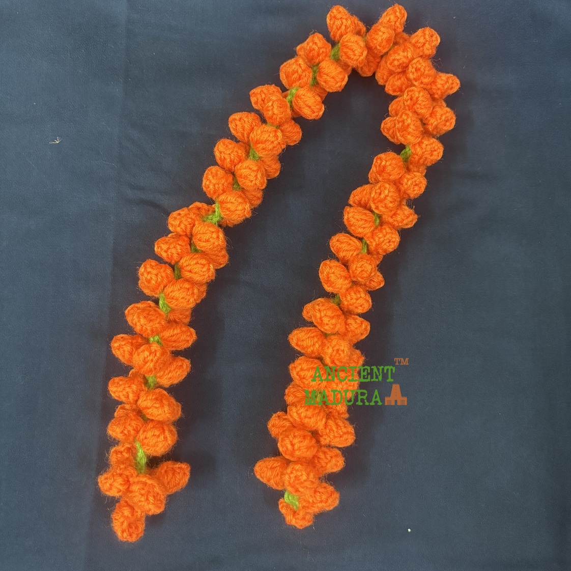 Artificial orange flower kanakambaram mala crocheted from woollen yarn, 22 inch hair string