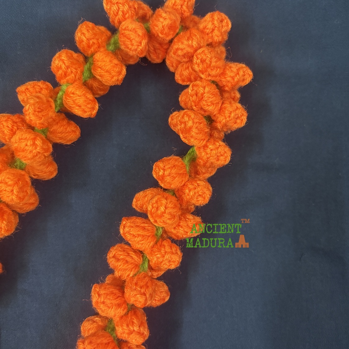 Artificial orange flower kanakambaram mala crocheted from woollen yarn, 22 inch hair string