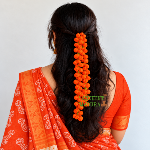 Artificial orange flower kanakambaram mala crocheted from woollen yarn, 22 inch hair string